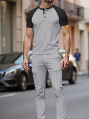 Men's grey patterned loungewear set with black raglan sleeves and drawstring pants.