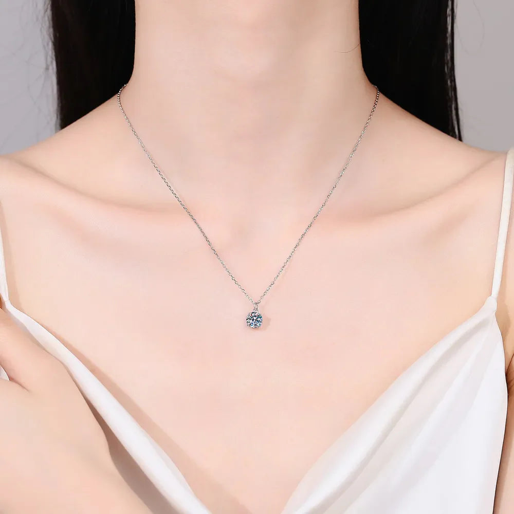 Solitaire moissanite pendant necklace in silver on a delicate chain.