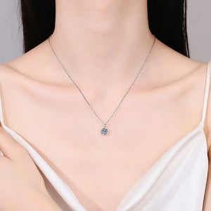 Solitaire moissanite pendant necklace in silver on a delicate chain.