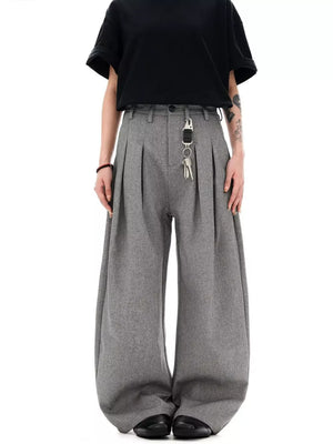Grey wide-leg pleated sweatpants with a key chain detail, styled with a black t-shirt.