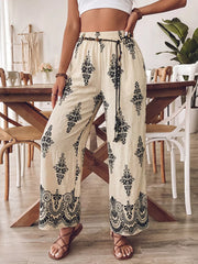 Beige wide leg maternity pants with black boho print and drawstring waist.
