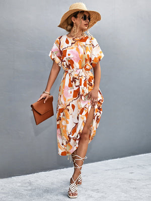 Abstract print midi dress in orange-red with tie waist and side slit.