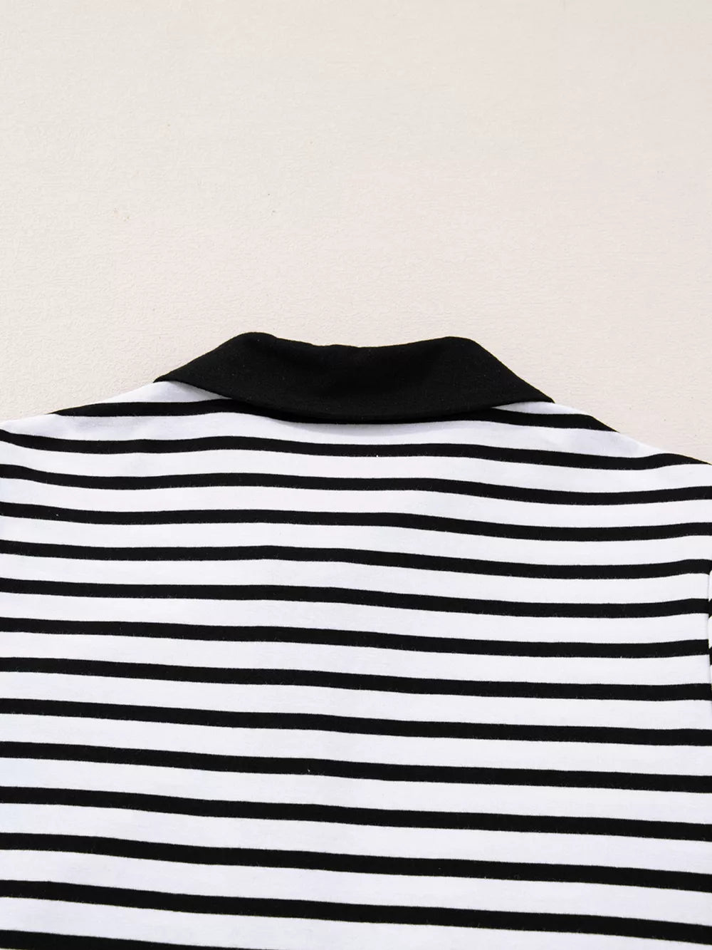 Striped collared long sleeve dress with black collar and button detail.
