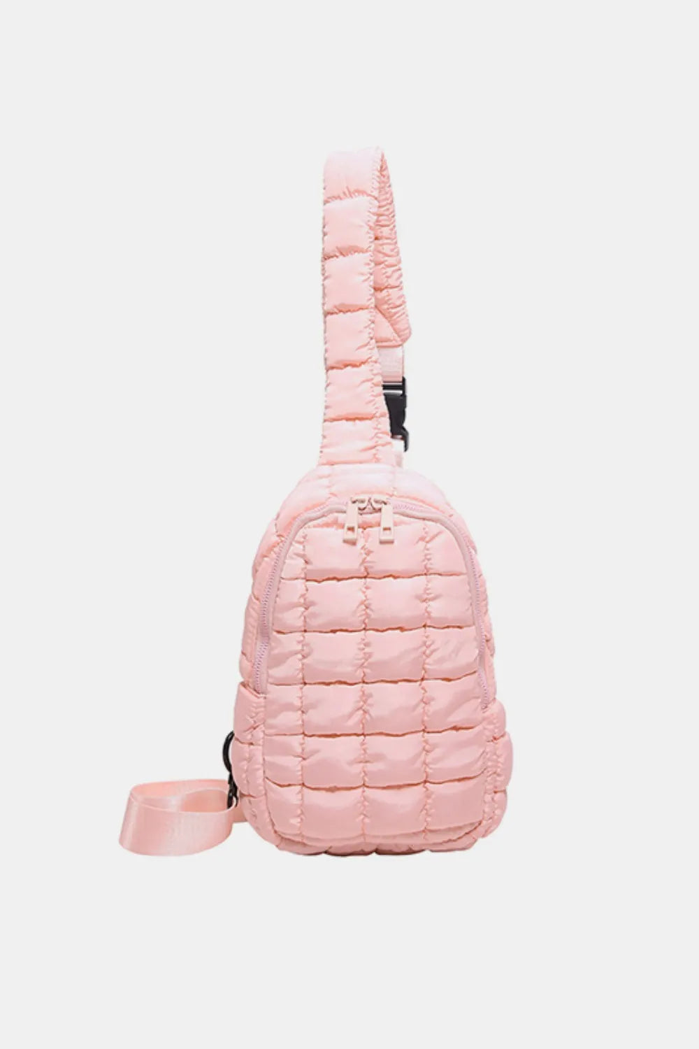 Padded sling bag in blush pink with quilted texture and adjustable strap.