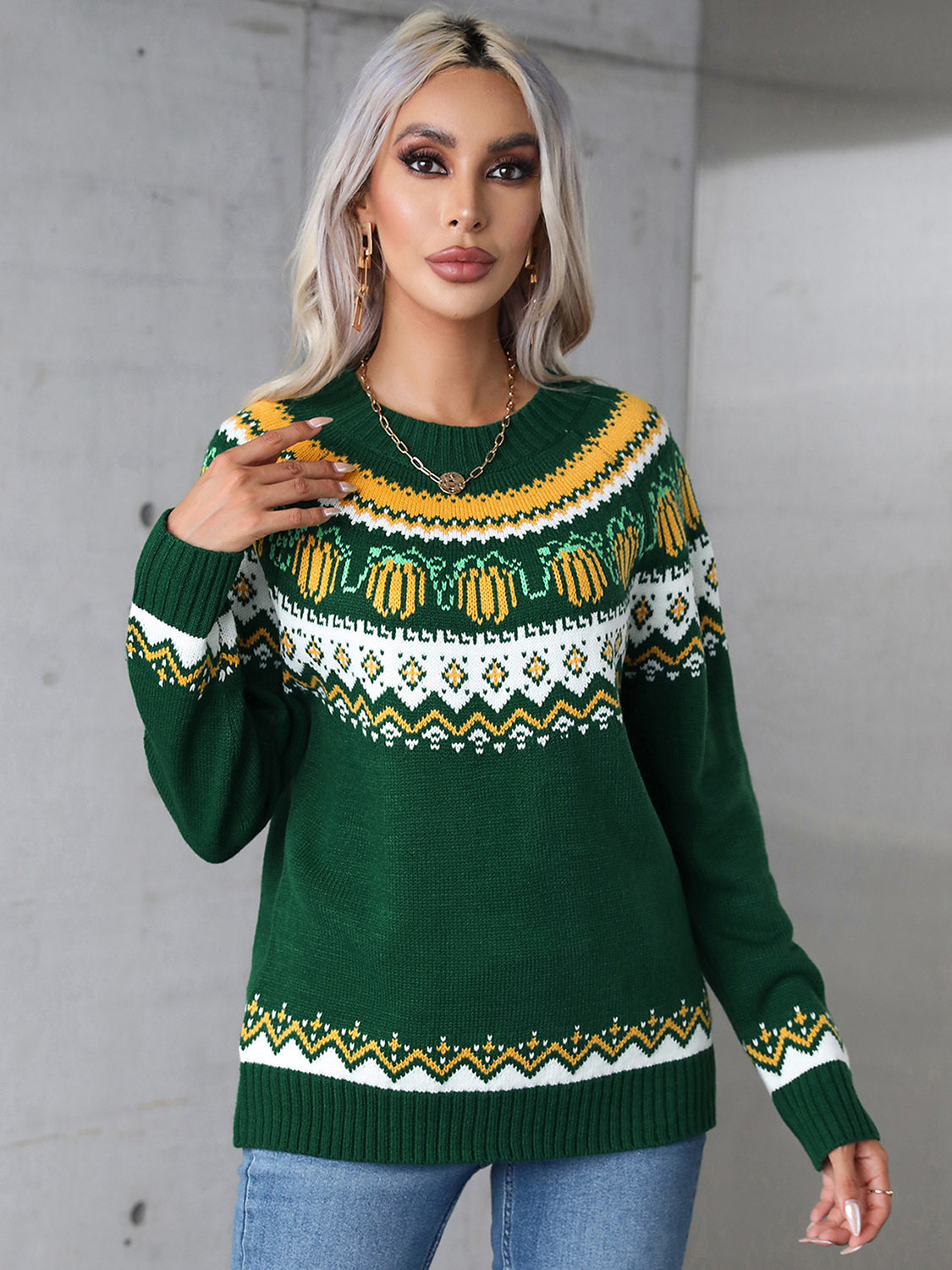Dark green acrylic crewneck sweater with autumnal Fair Isle pattern and pumpkin motifs.