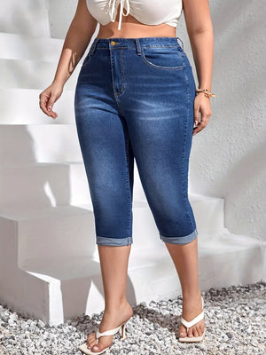 Dark blue denim capri jeans with high waist and cuffed hems.