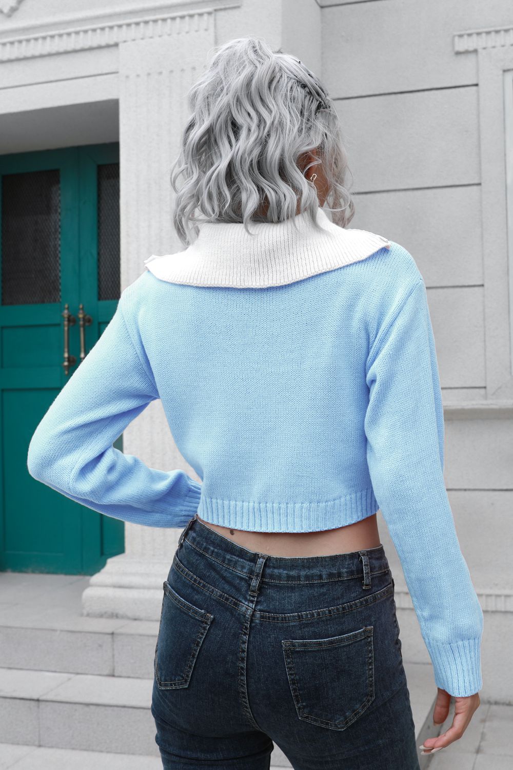Light blue acrylic cropped sweater with white collar and zip detail