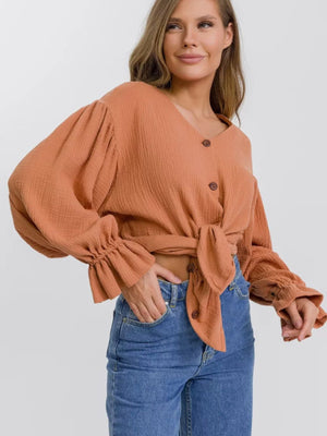 Ochre textured puff sleeve blouse with ruffled cuffs and tie front