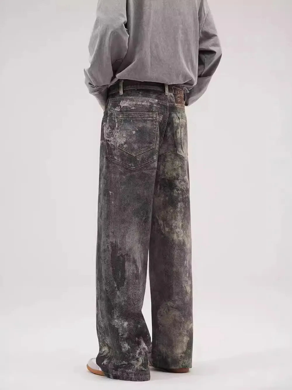 Dark gray wide-leg jeans with distressed details and a relaxed fit.