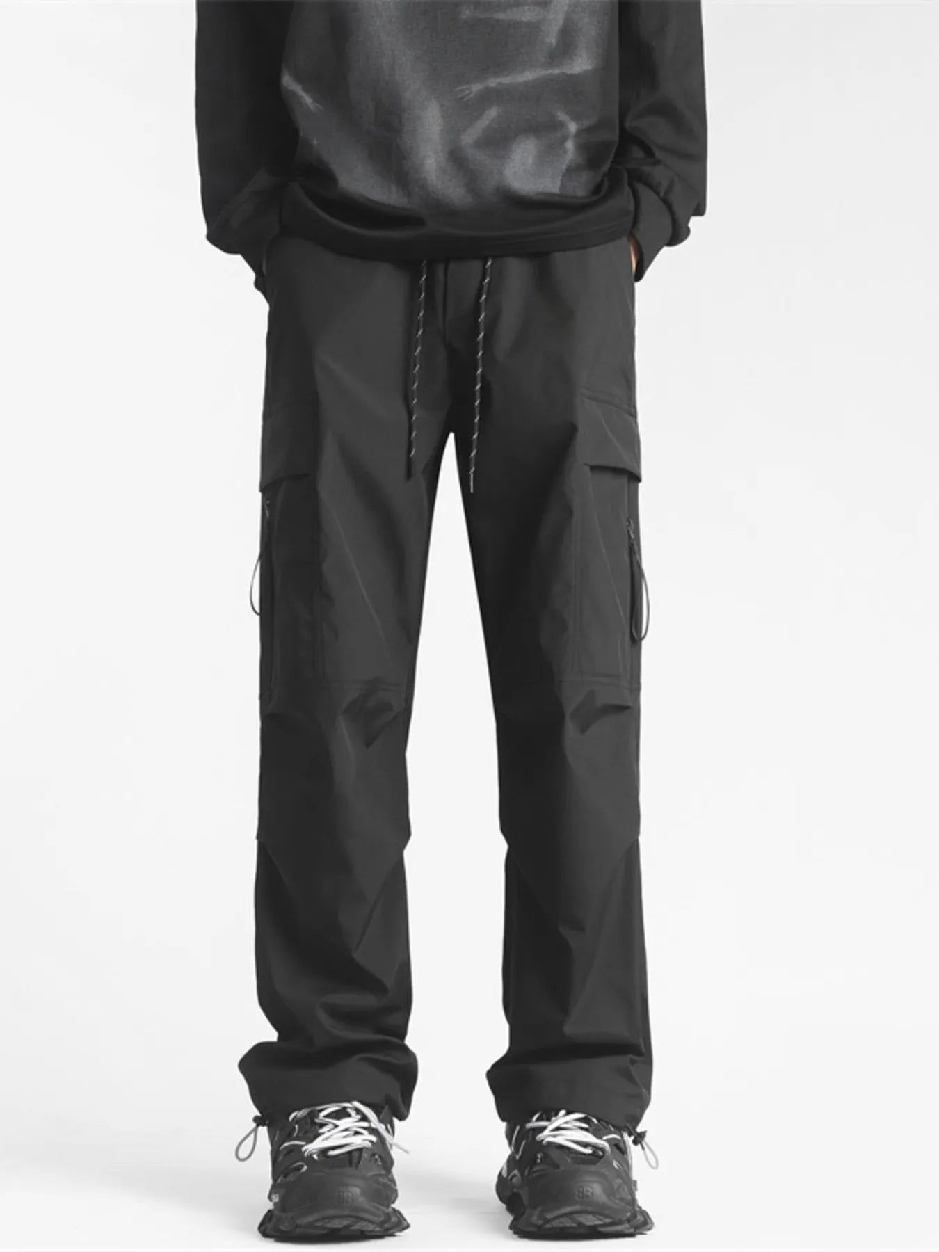 Plus-size black loose fit cargo pants with drawstring waist and multiple pockets.