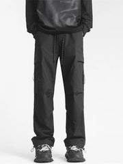 Plus-size black loose fit cargo pants with drawstring waist and multiple pockets.