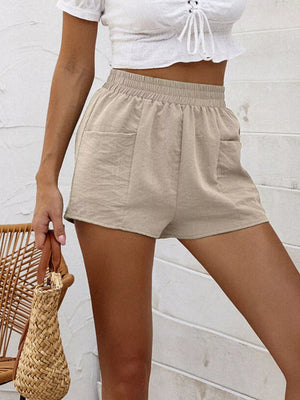 Beige elastic waist shorts with pockets, casual women's loungewear.