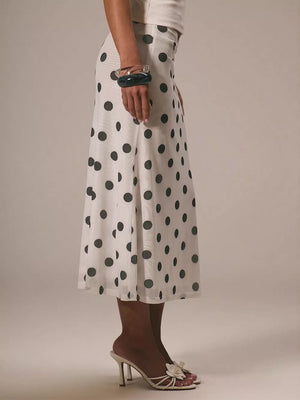 Classic polka dot midi skirt in white with black dots, featuring a sheer hem.