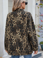 Leopard print denim utility jacket with a classic collar and button cuffs.