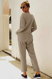 Relaxed linen-blend jumpsuit in khaki with button details and cuffed ankles.