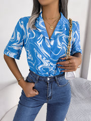 Sky blue swirl print camp collar blouse with short sleeves.