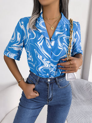 Sky blue swirl print camp collar blouse with short sleeves.