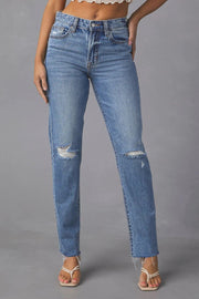 Distressed straight leg denim jeans in medium wash cotton with ripped knees and frayed hem.