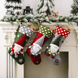 Gnome embellished holiday stockings trio in red, green, and charcoal with polka dot and star details.