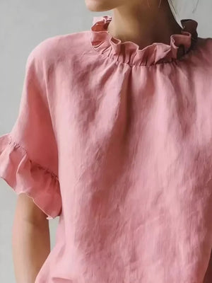 Pink ruffled neck half-sleeve shirt with ruffled cuffs.