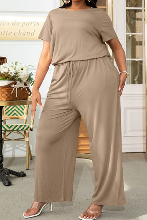 Tan relaxed fit jumpsuit with drawstring waist and wide legs.