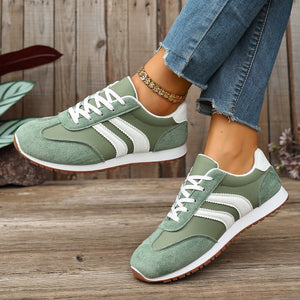 Green suede lace-up sneakers with white stripes and brown soles