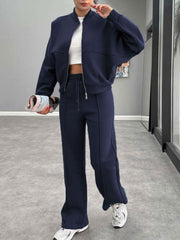 Dark blue bomber jacket and wide-leg tracksuit with drawstring waist and contrast stitching.