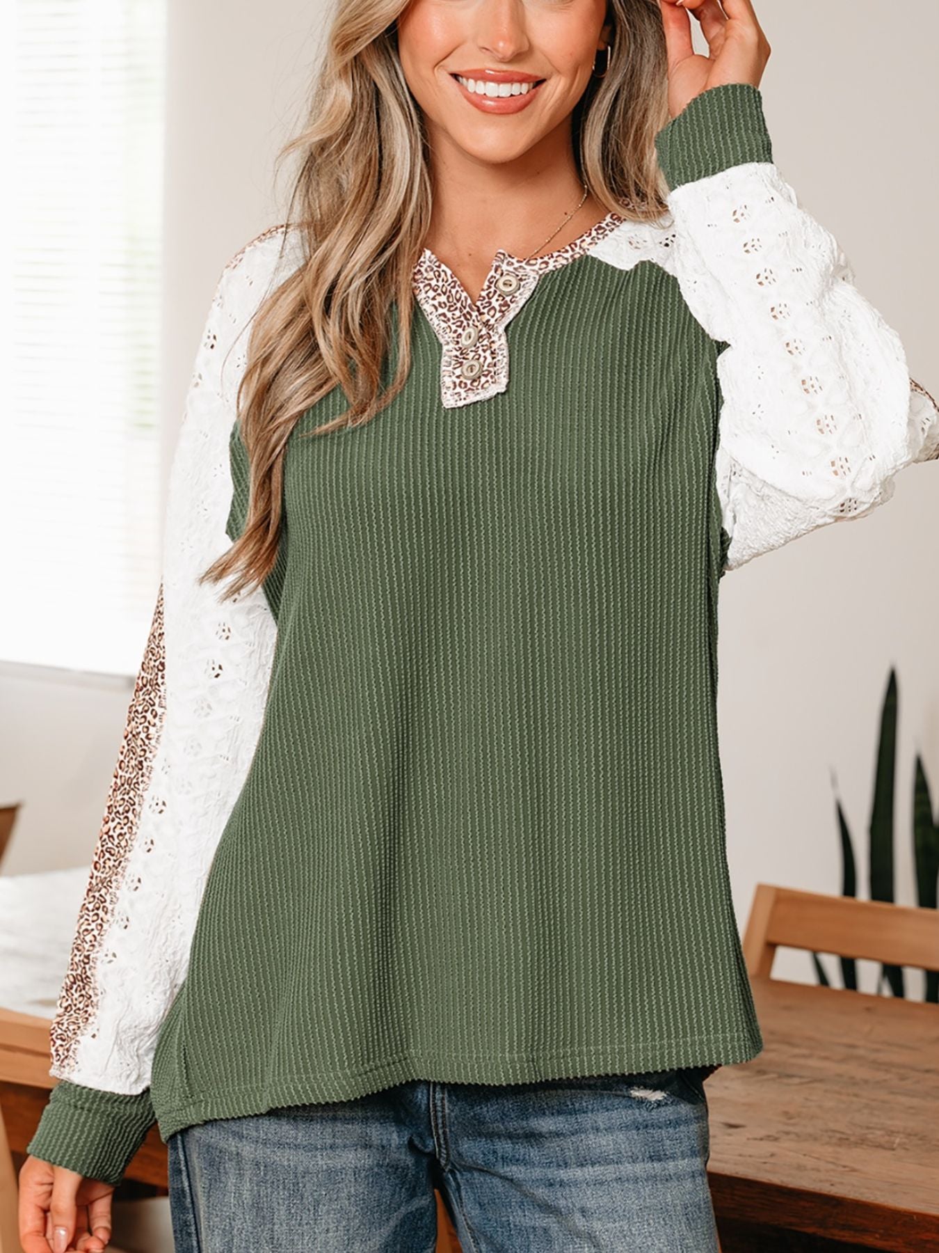 Dark green waffle knit henley top with lace sleeves and leopard print trim.