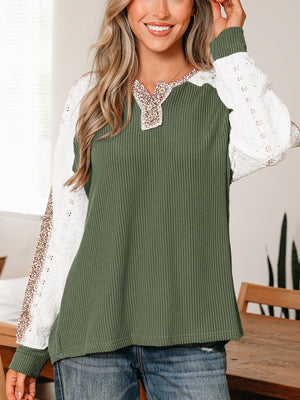 Dark green waffle knit henley top with lace sleeves and leopard print trim.