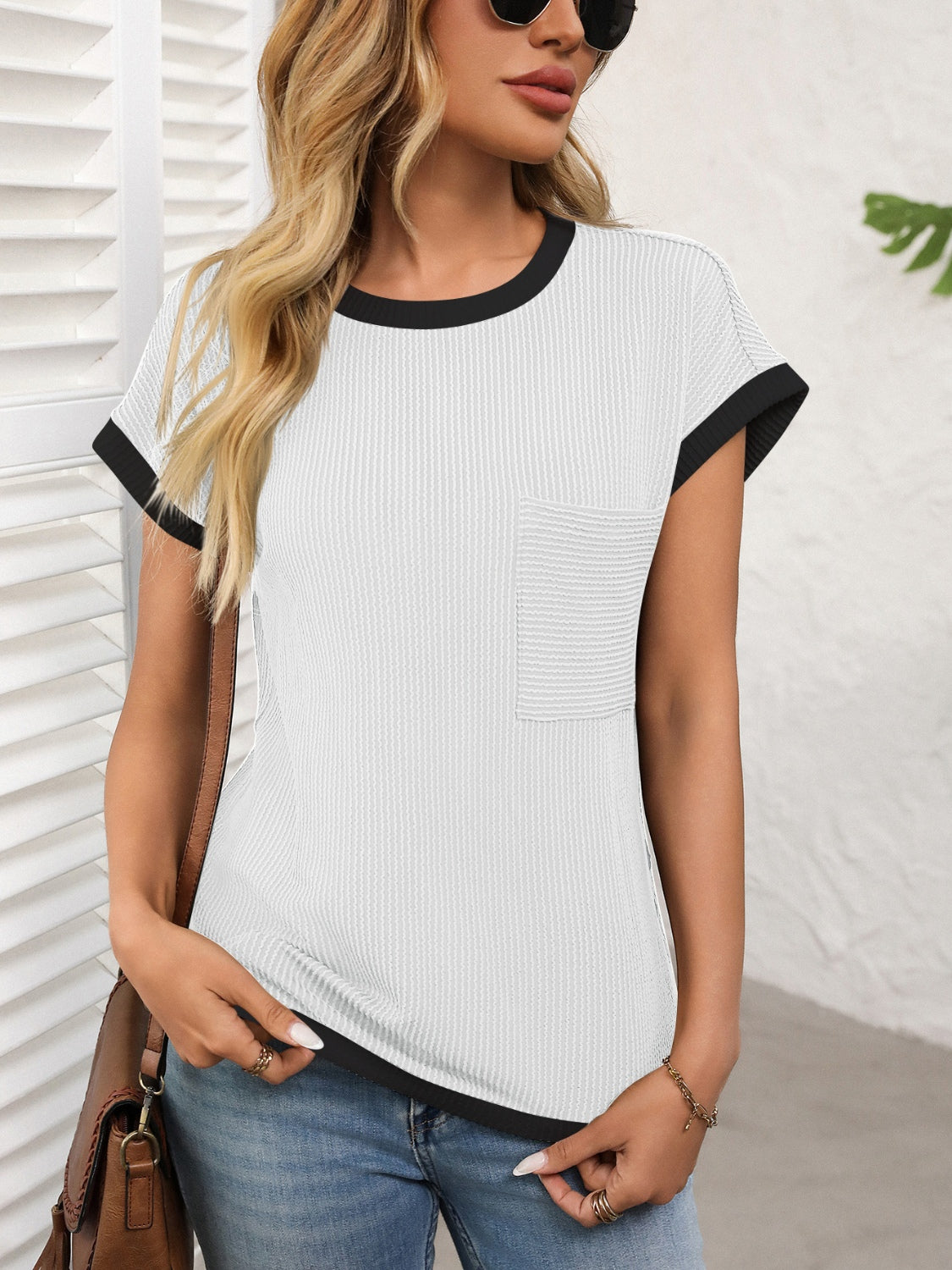 White ribbed knit tee with black contrast piping and chest pocket.