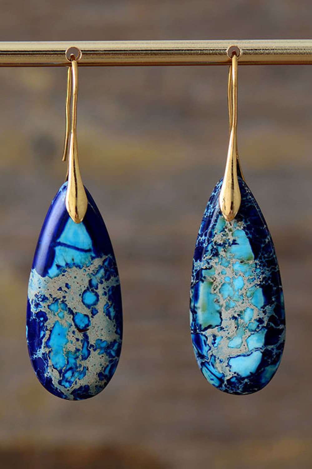 Ocean Jasper dangle earrings in blue/gold with teardrop stones and gold hooks.