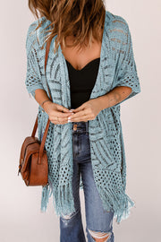 Light blue open knit chevron fringe cardigan with short sleeves and boho styling.