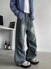 Relaxed fit blue denim cargo jeans with drawstring waist and visible stitching details.