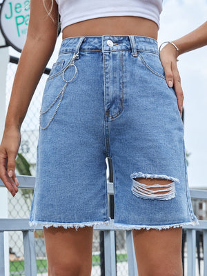 Light wash denim Bermuda shorts with distressed details and chain accent.