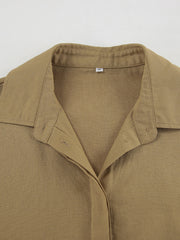 Cropped long sleeve top with collared neckline and button-up front in tan cotton.