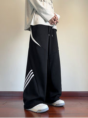 Black wide-leg sweatpants with white stripe details and a drawstring waist.