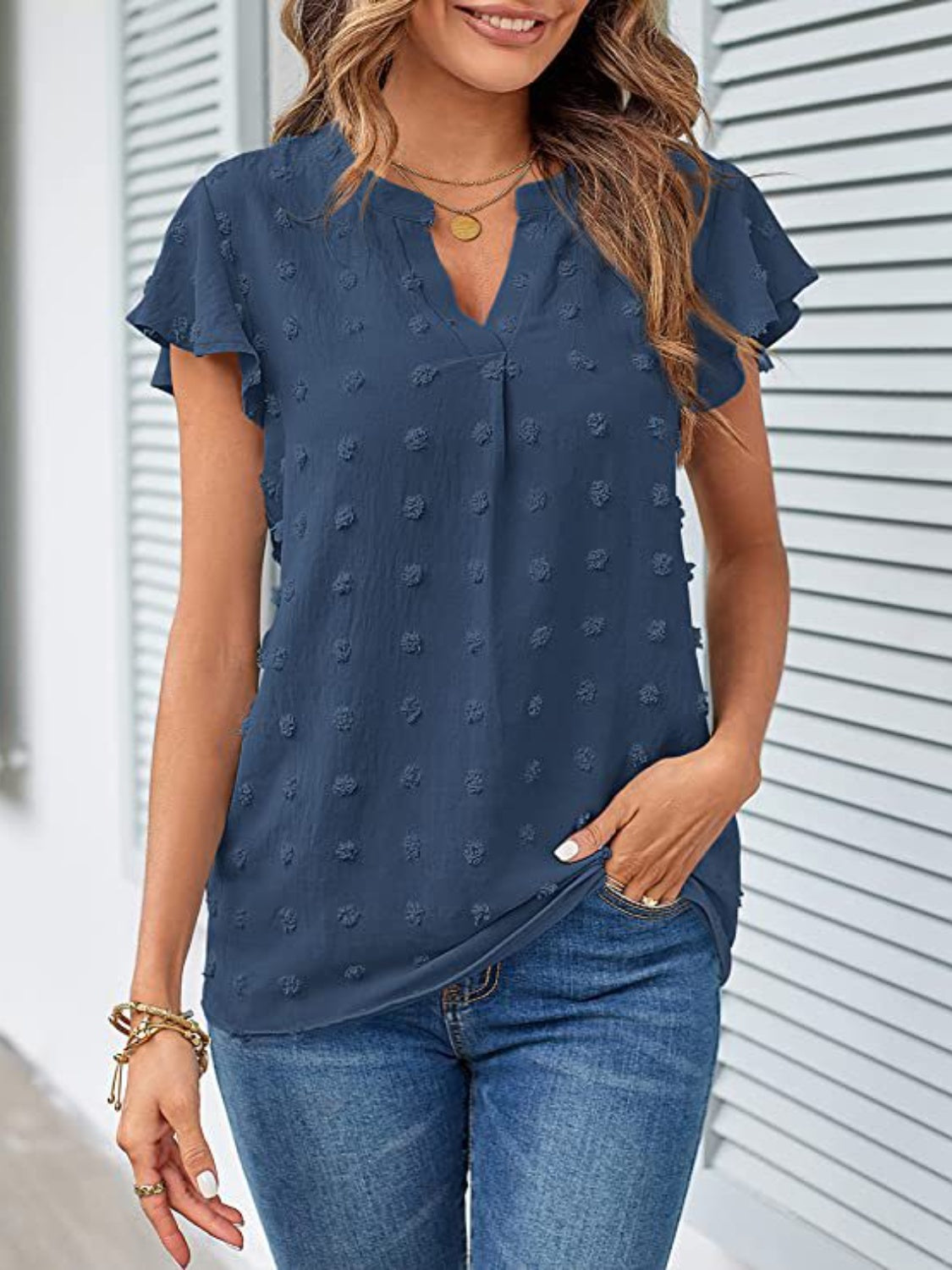 Flutter sleeve Swiss dot blouse in Dusty Blue with V-neck and ruffle sleeves.