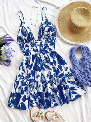 Vibrant floral V-neck mini dress with cutout detail and tiered hem.