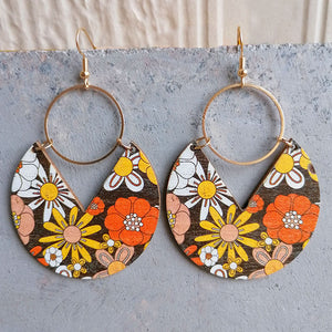 Wood drop earrings with retro floral pattern in orange, yellow, and white.
