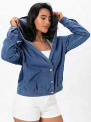 Medium wash denim bomber jacket with hood and button closure.