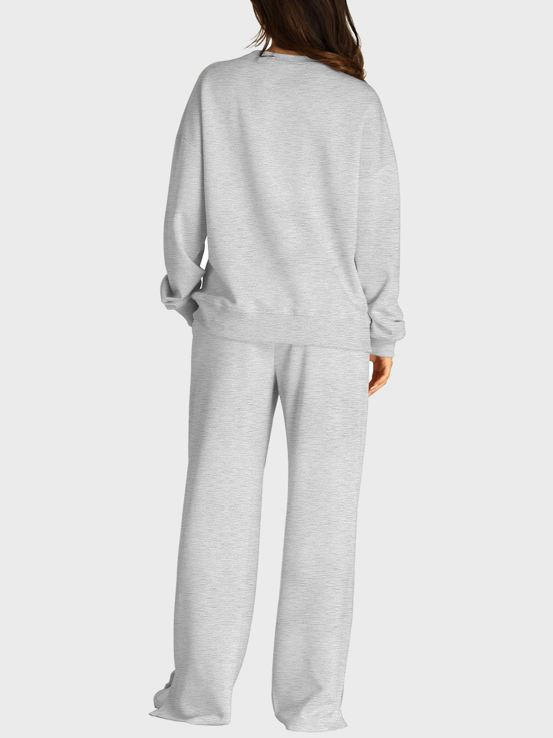 Light gray seamed loungewear set with crewneck sweatshirt and wide-leg trousers with slit front detail.