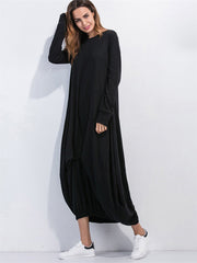 Black balloon hem maxi dress with long sleeves and crew neck, styled with sneakers.