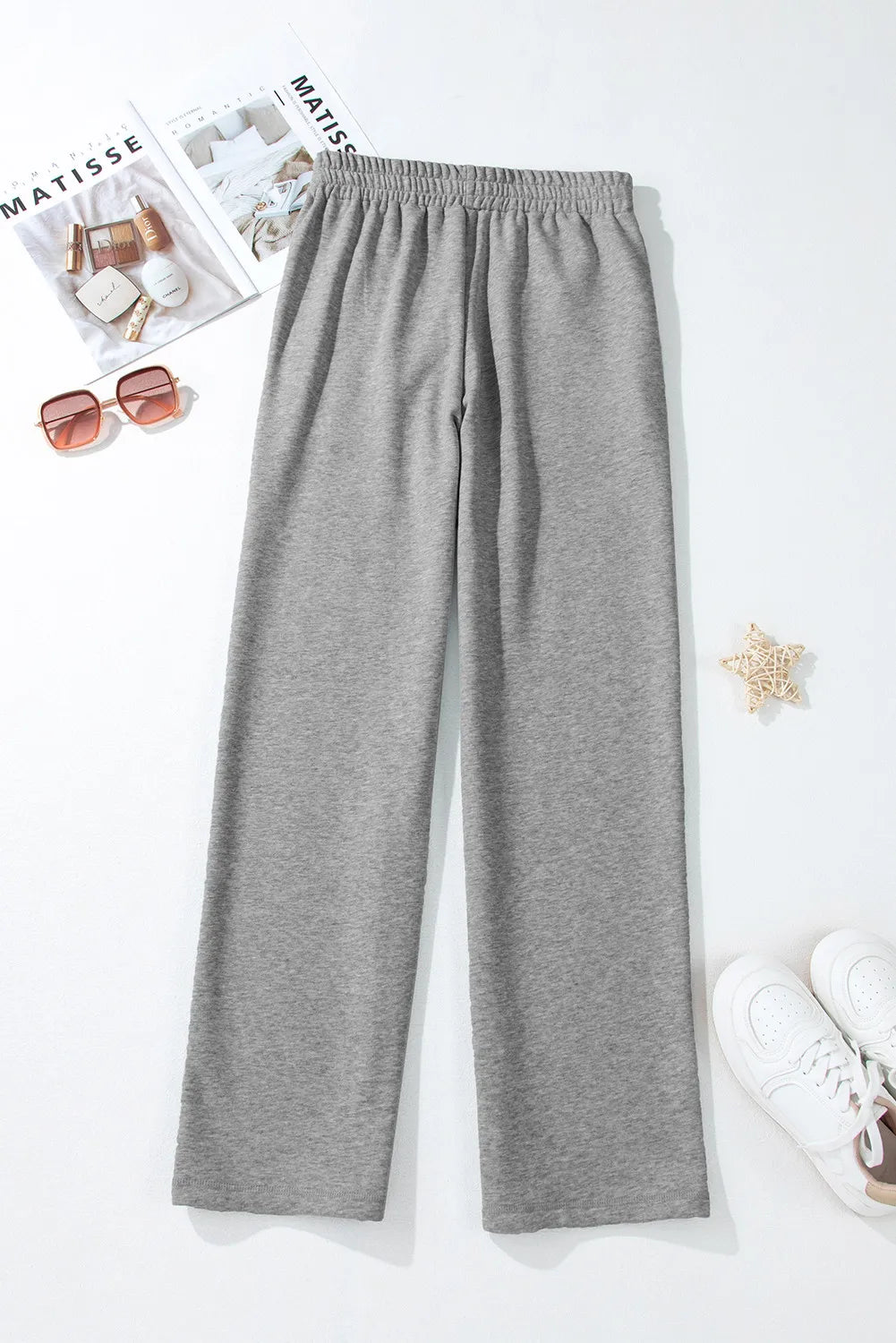 Relaxed-fit grey lounge joggers with elastic waistband and drawstring detail.