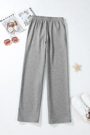 Relaxed-fit grey lounge joggers with elastic waistband and drawstring detail.