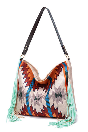 Southwestern fringe hobo bag with geometric pattern and mint green tassels.