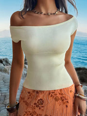 White off-shoulder knit top with short sleeves and a ribbed bodice.