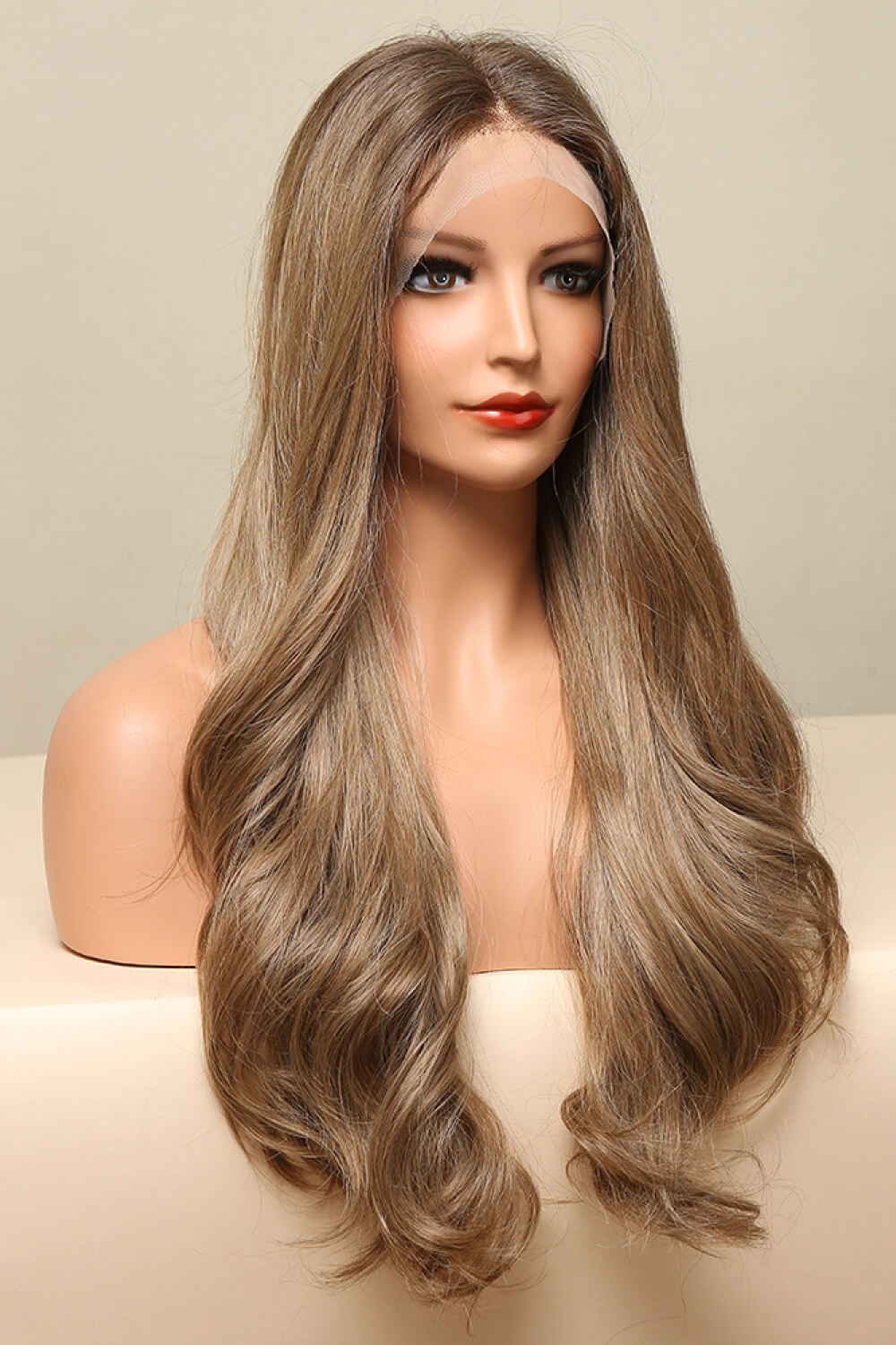 Luxe cascading wave lace front wig in golden brown with a natural hairline and loose curls.