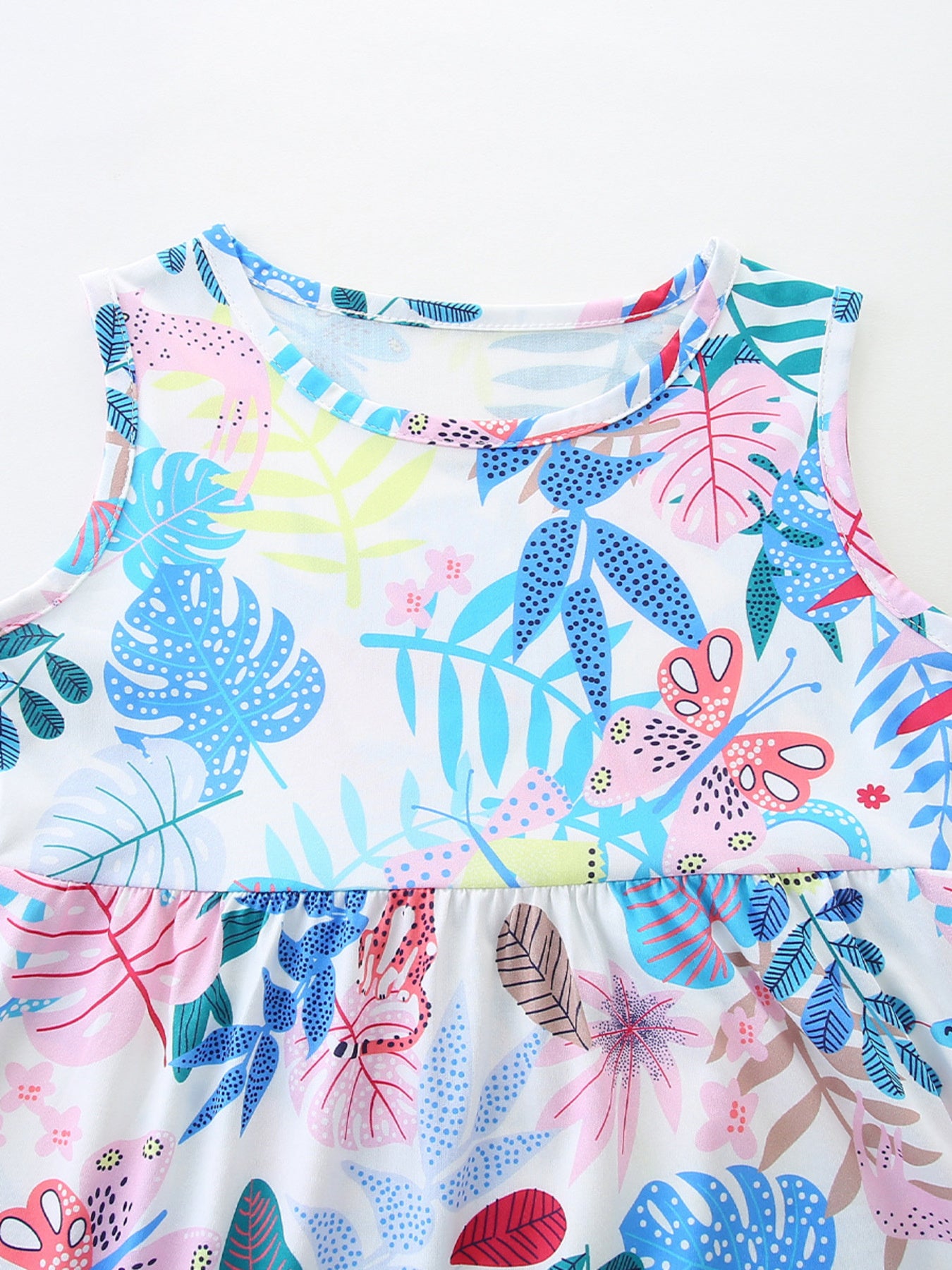 Baby girls cotton dress with playful tropical leaf and butterfly print, round neck, sleeveless.