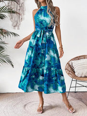 Blue floral halter neck midi dress with tiered skirt and belted waist.