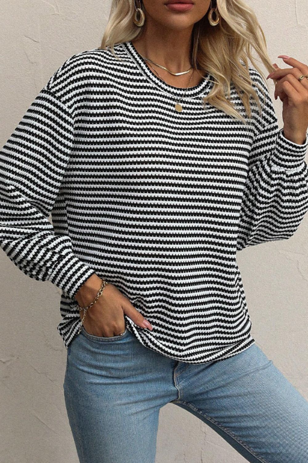 Textured stripe balloon sleeve top in black and white, casual crew neck blouse.